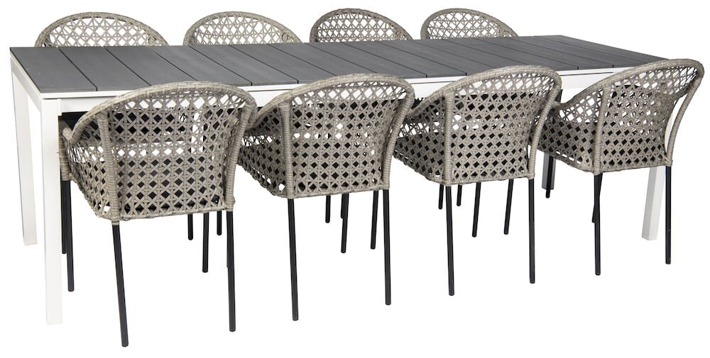 Kahdeksan rottinkituolia pitkänomaista ruokapöytää ympäröimässä.