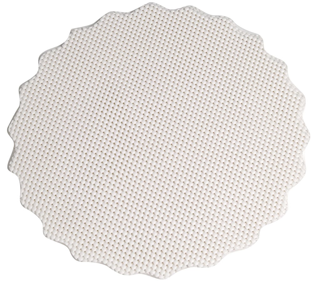 Runt vitt glidskydd i gummi med strukturerad yta.