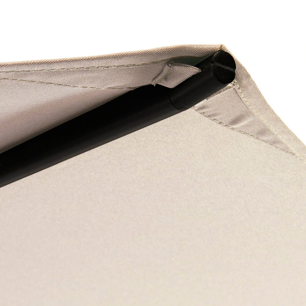 Hiekanvärinen varjokangas mustalla tangolla kulmassa.