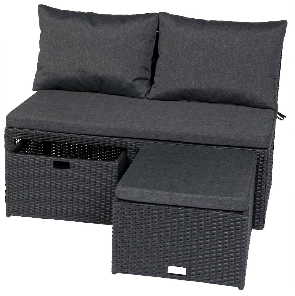 Svart loungesofa med puter og to oppbevaringsbokser.