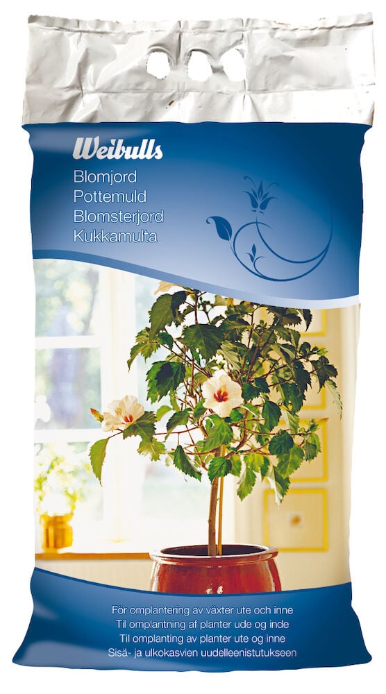 En påse blomjord med bild på grön krukväxt.