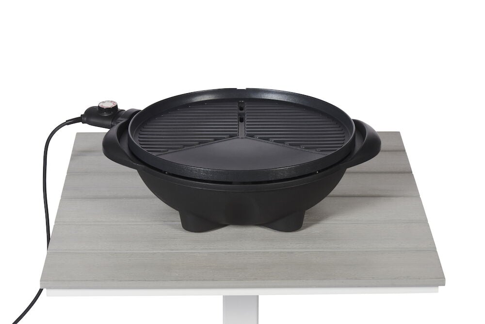 Rund svart elgrill med termostat på vit bordsyta.