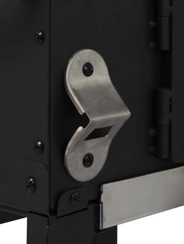 Fastmontert flaskeåpner på svart kullgrill.