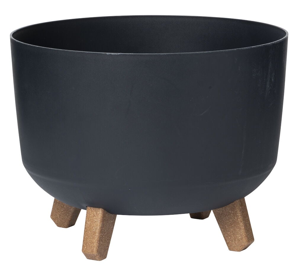 Svart krukke i plast med fire brune ben.