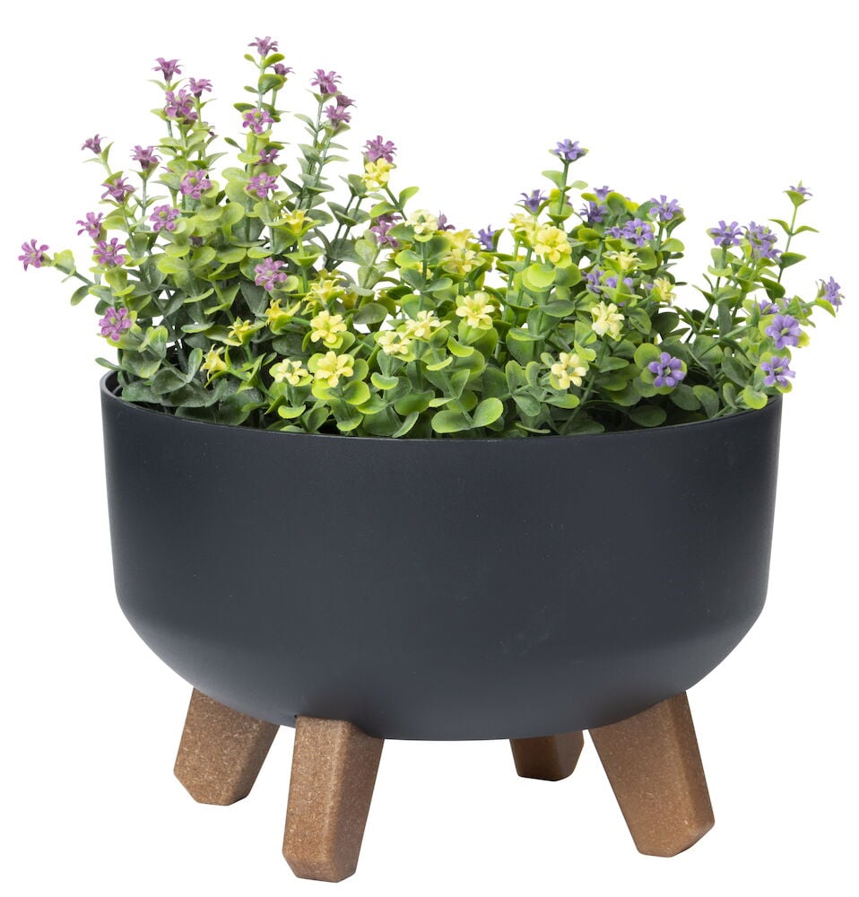 Svart krukke med fargerike blomster og brune ben.