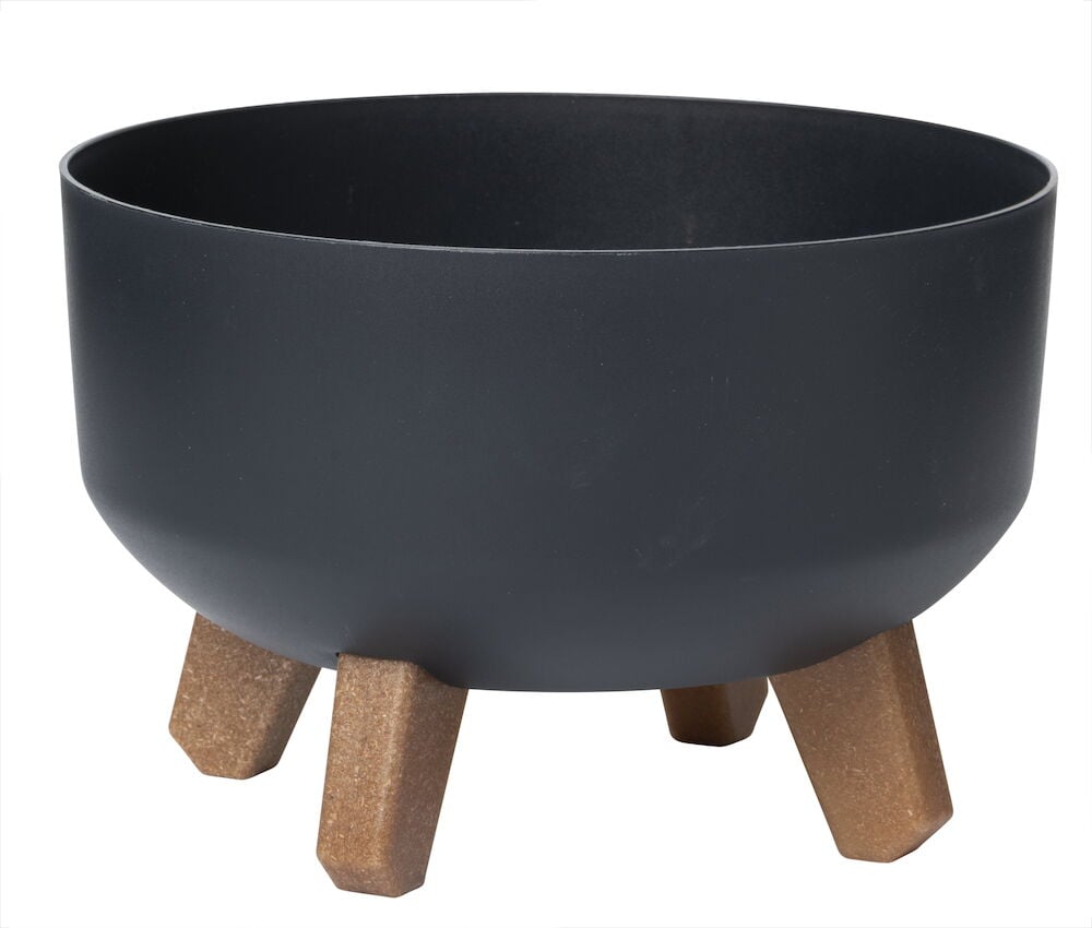 Svart krukke i plast med fire brune bein.