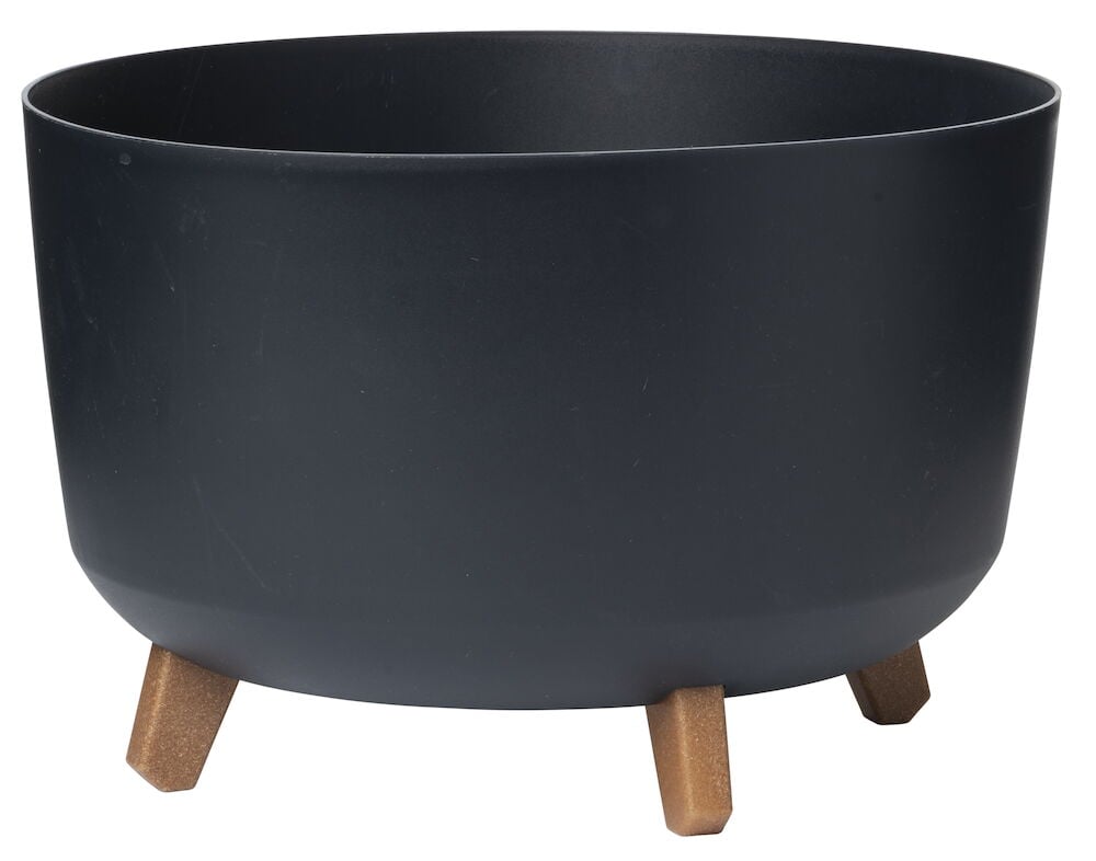 Musta pyöreä ruukku, jossa on neljä ruskeaa jalkaa.
