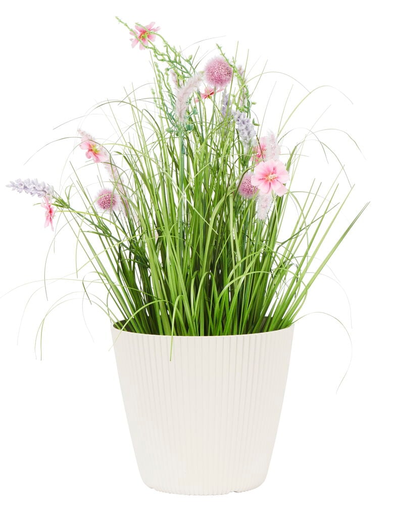 Ljus sandfärgad plastkruka med gröna växter.