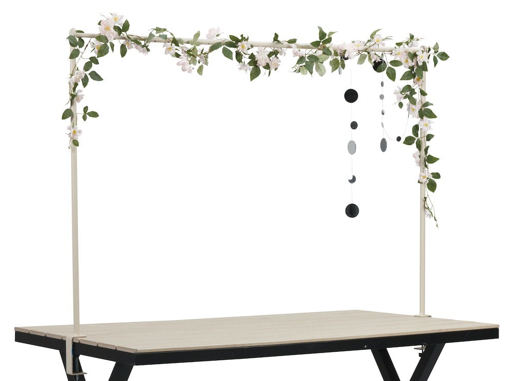 Beige teräskehys koristeltu pöydällä olevilla kukilla.