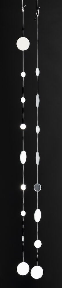 To hengende mobiler med hvite runde former.