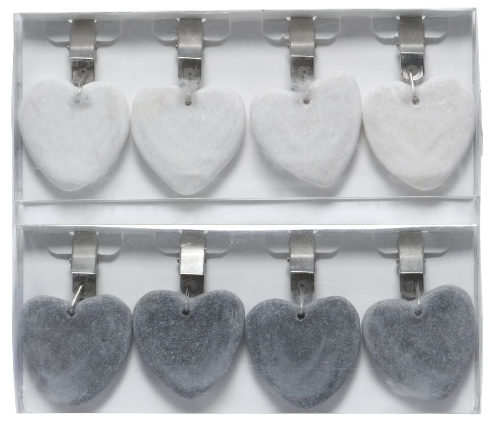 Kahdeksan sydämenmuotoista kivipainoa metallikiinnikkeillä.