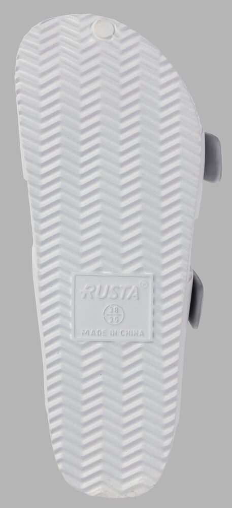 Undersida av grå sandal med mönstrad sula.