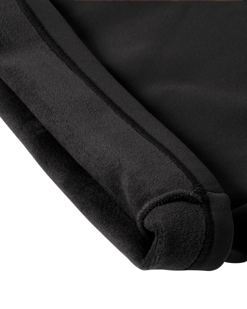 Närbild på svarta Fuskpälsleggings Bootcut, visar slät utsida och mjuk fuskpälsfoder.