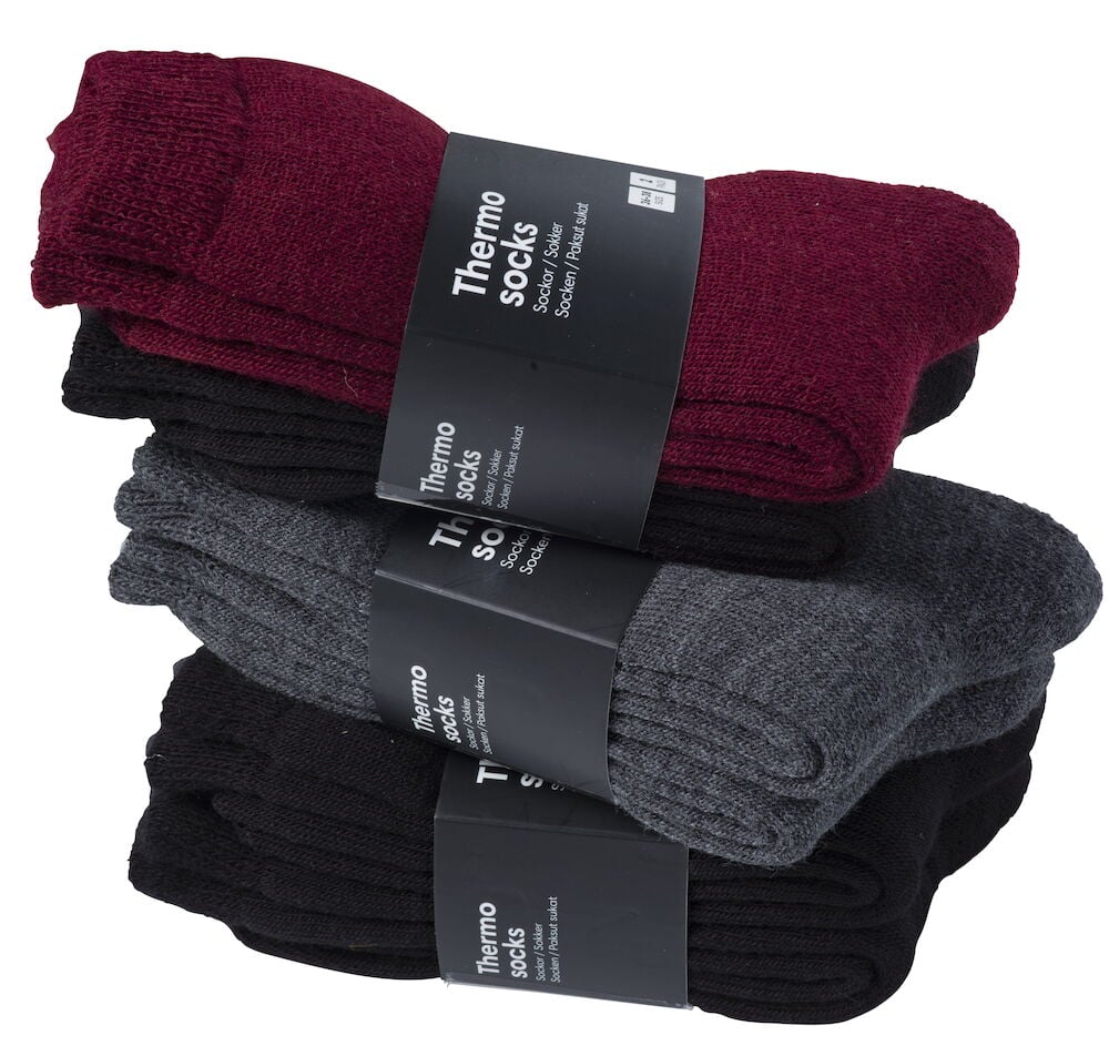 Tre paket värmesockor i olika färger.