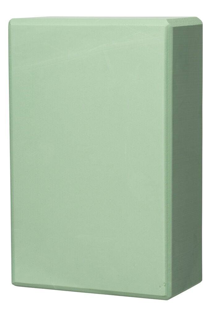 Rektangulärt grönt yogablock med rundade kanter.