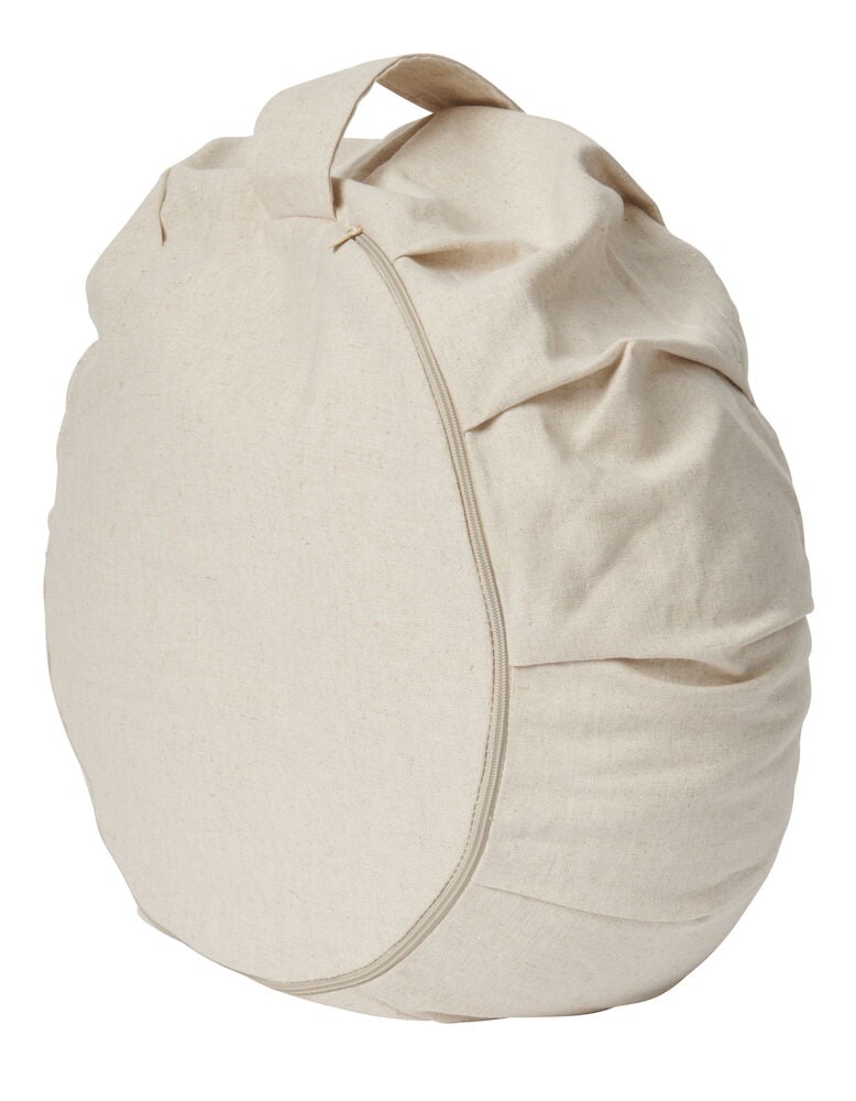 Rund beige meditationskudde med handtag och dragkedja.