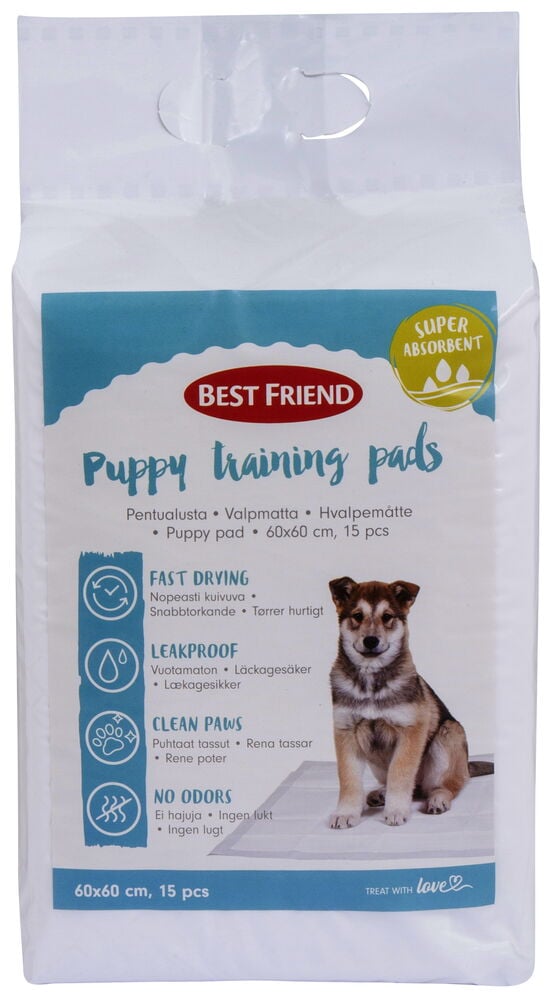 Förpackning med valpmattor och bild på en valp.