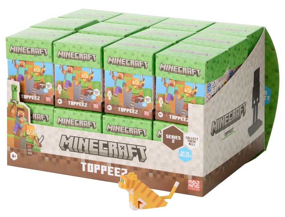 Esittelylaatikko, jossa 12 vihreää Minecraft Toppeez yllätyslaatikkoa ja irrallinen oranssi pikselikissa Figuuri Minecraft 5-6 cm Valikoima.