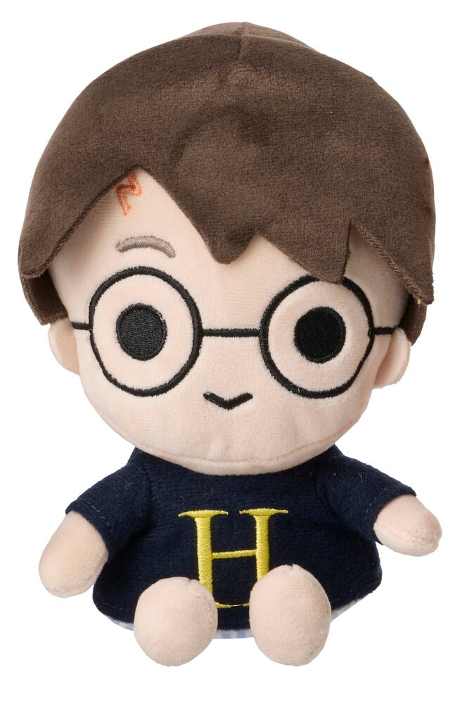 Pehmolelu Harry Potter ruskeilla hiuksilla, laseilla, arpella ja laivastonsinisellä paidalla, jossa keltainen H.