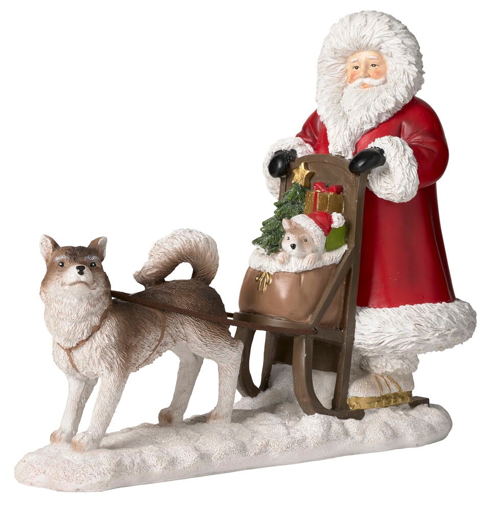 Eine Weihnachtsfigur von Weihnachtsmann im roten Anzug, ein Hund zieht einen Schlitten mit Igel und Geschenken.