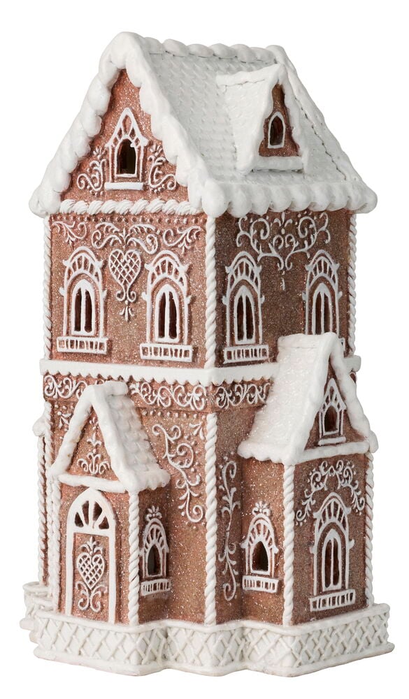 Ett dekorativt pepparkakshus i brunt glitter med intrikata vita kristyrdetaljer, fönster och en dörr.