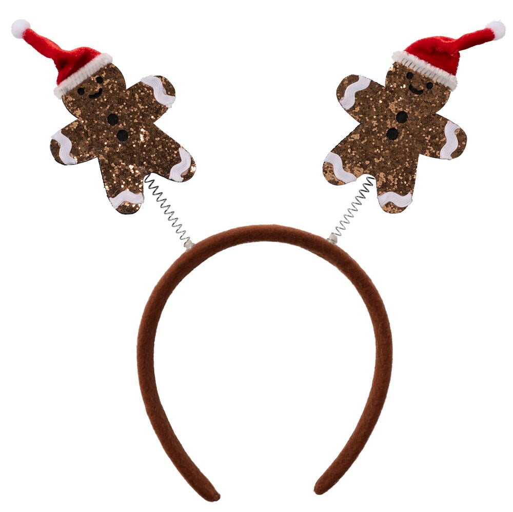 Weihnachtsaccessoires. Braunes stoffbezogenes Haarband mit zwei glitzernden Lebkuchenmännern mit roten Weihnachtsmützen auf Federn.