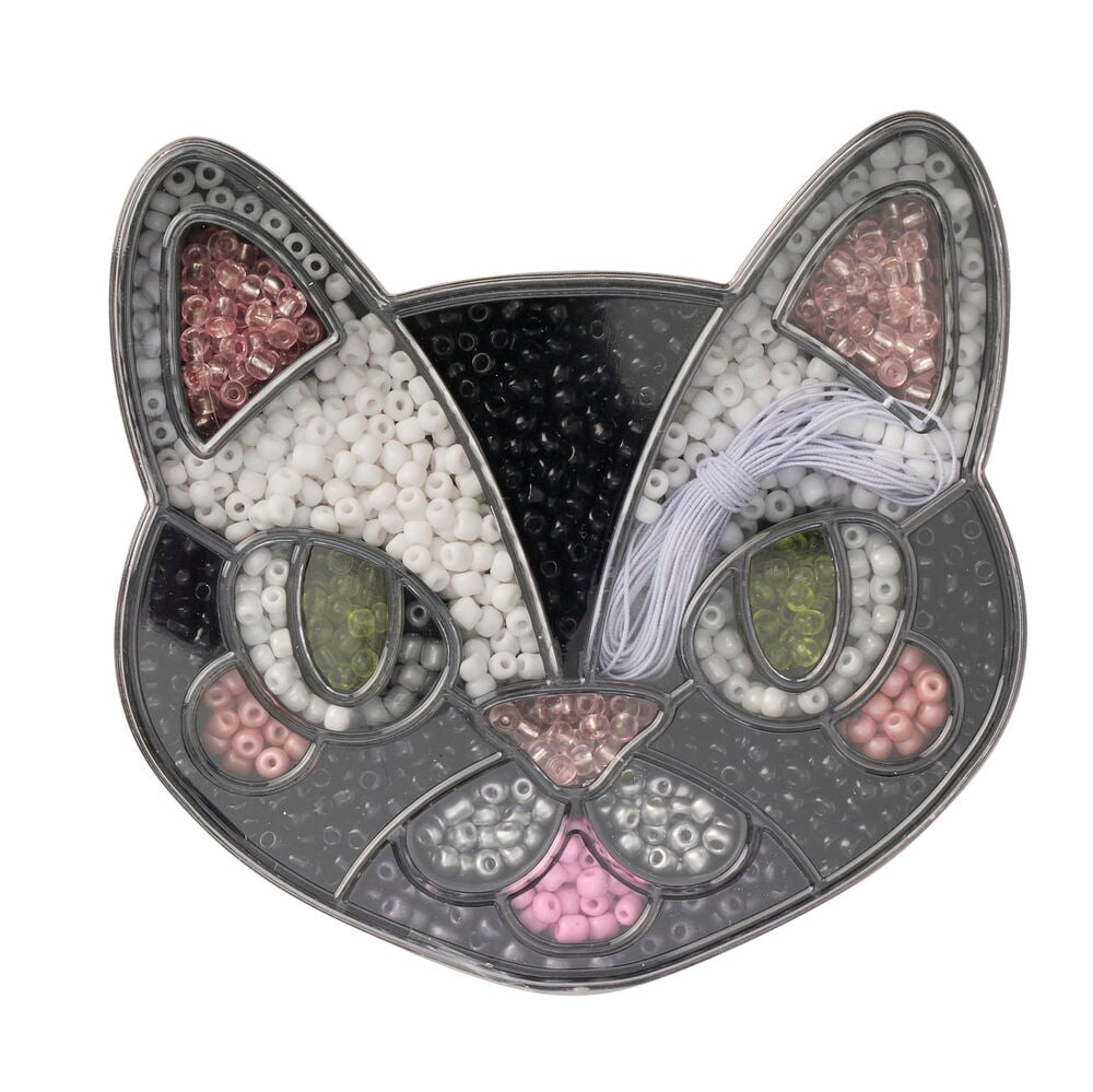 Perlenset Halloween, ein transparenter katzenkopfförmiger Behälter mit weißen, schwarzen, rosa, grünen, silbernen Perlen und weißem Faden.