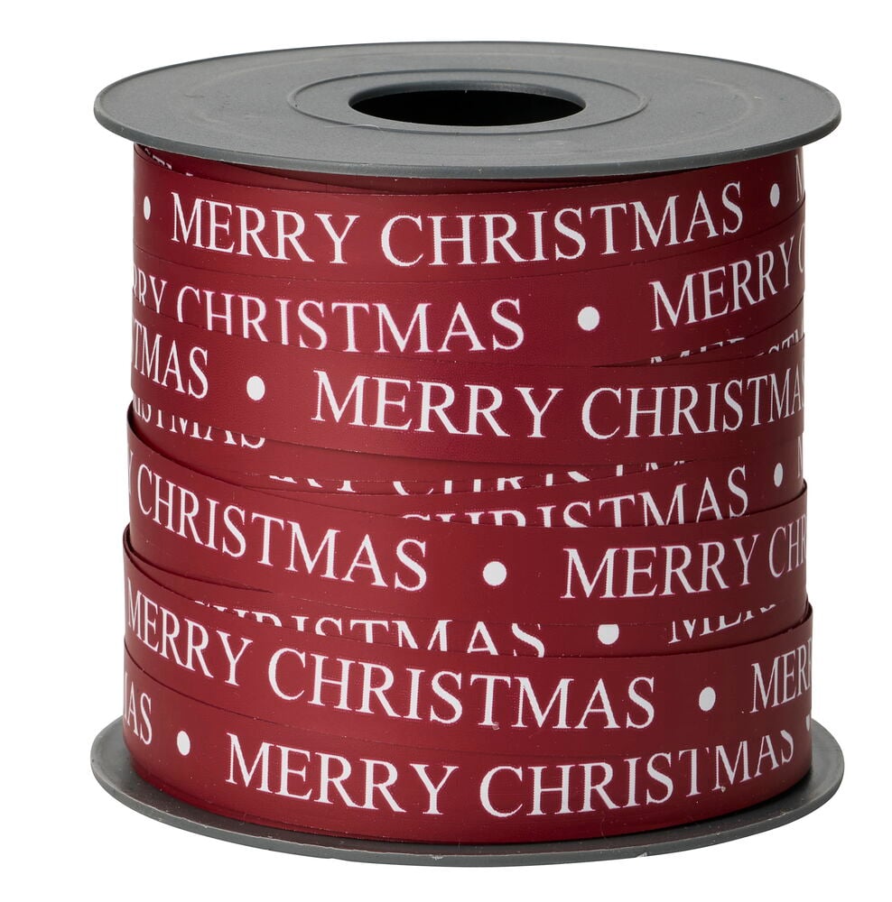 Rotes Geschenkband mit weißem 'MERRY CHRISTMAS'-Text und Punkten, auf einer grauen Spule.