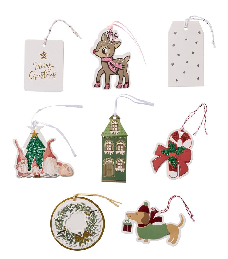 Geschenketiketten 4–5er-Pack, darunter zwei Etiketten, ein Reh, Zwerge, ein Haus, eine Zuckerstange, ein Kranz und ein Hund.