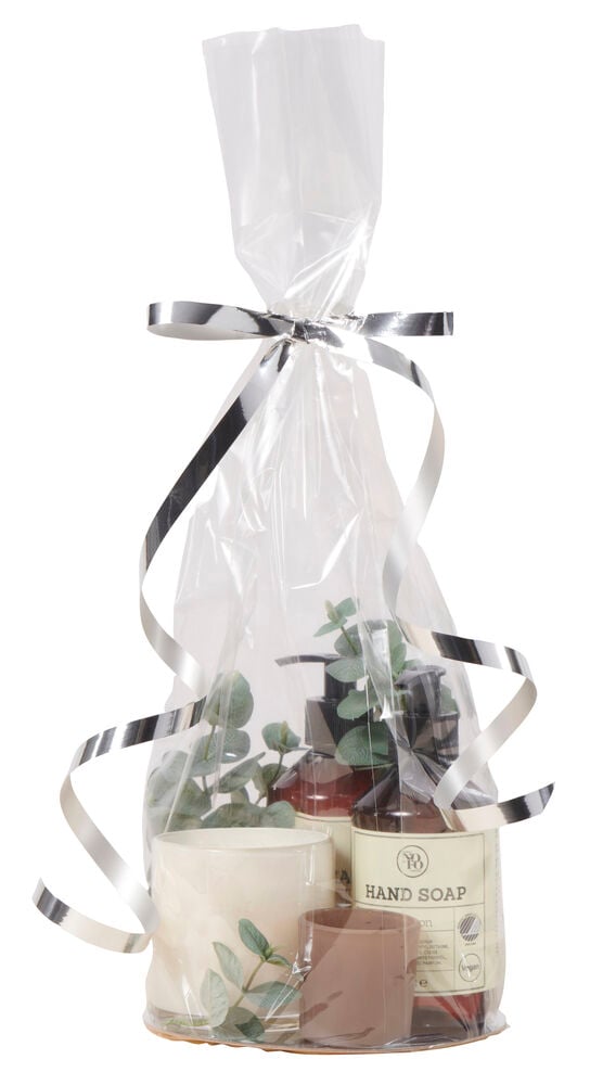 Transparent cellofanpåse med presentartiklar och guldbotten.