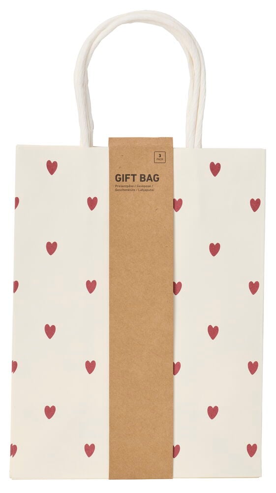 Vit presentpåse 3-pack med rött hjärtmönster, vita tvinnade handtag och en brun etikett.