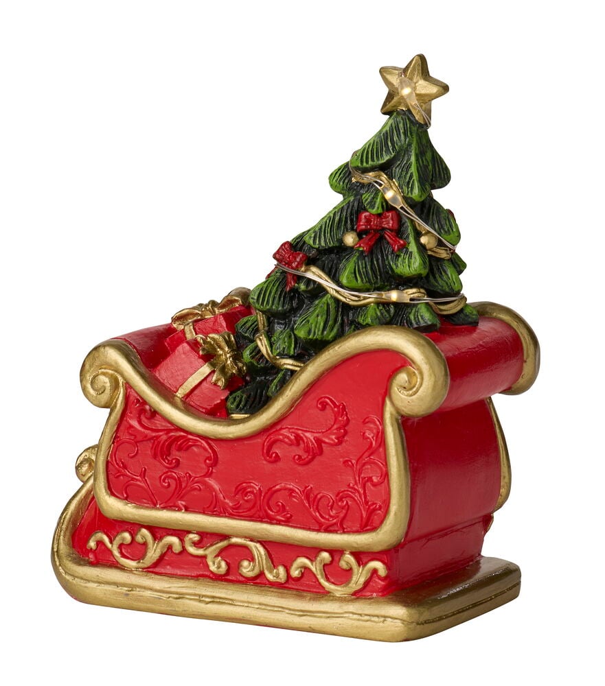 Roter Schlitten mit Goldrand, der einen LED Weihnachtsbaum mit Stern und rote Geschenkboxen enthält.