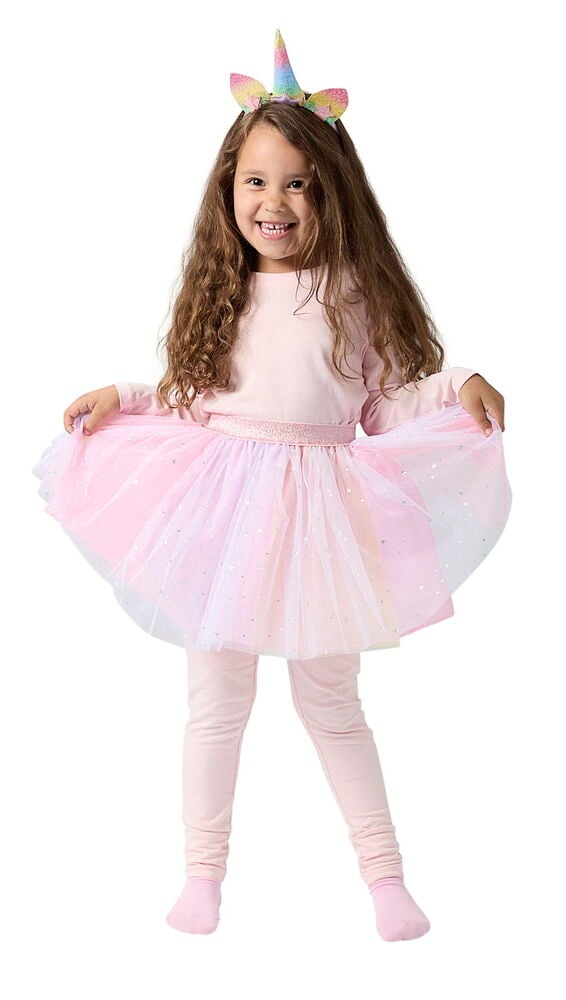 Verkleidungsset, Kinder Einheitsgröße: Ein lachendes Kind trägt einen pinken Einhorn-Haarreif, pinkes Top, glitzerndes mehrfarbiges Tutu und pinke Leggings.
