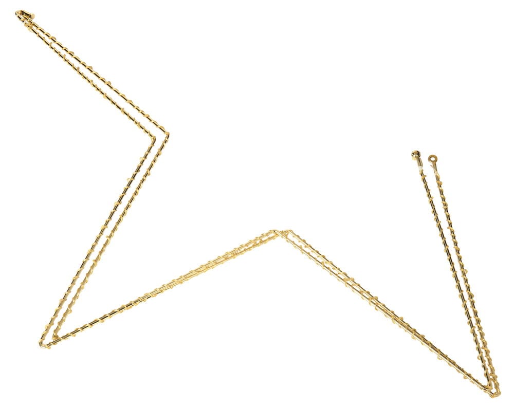 Guldfärgad stjärnformad dekorationsbelysning i metall.