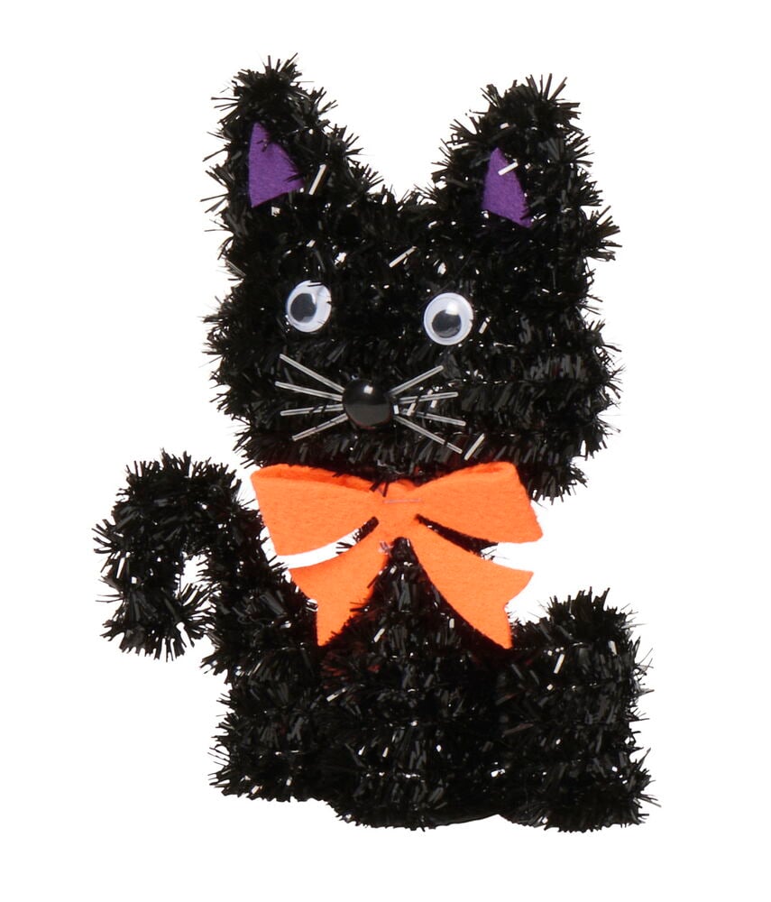 Svart glitterfigur Halloween dekoration som en katt, med rörliga ögon, vita morrhår, lila öron och orange rosett.