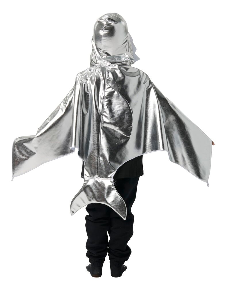 Ett barn bär en silverfärgad metallisk Halloween cape, barn med huva, vingar och stjärt över svarta byxor.