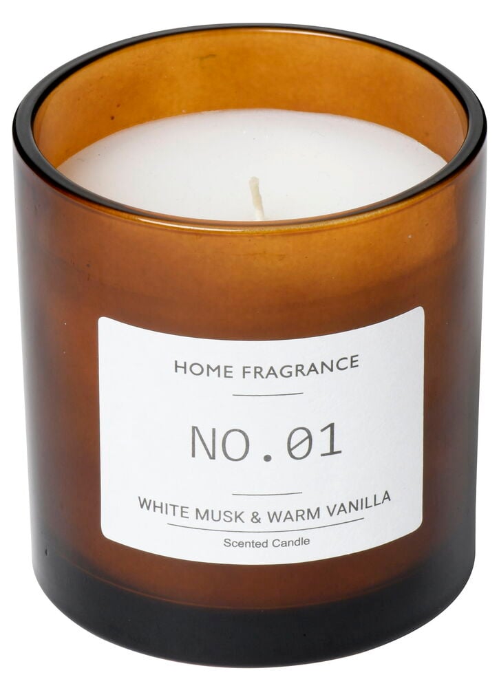 Brunt doftljus i glasbehållare med vit etikett.