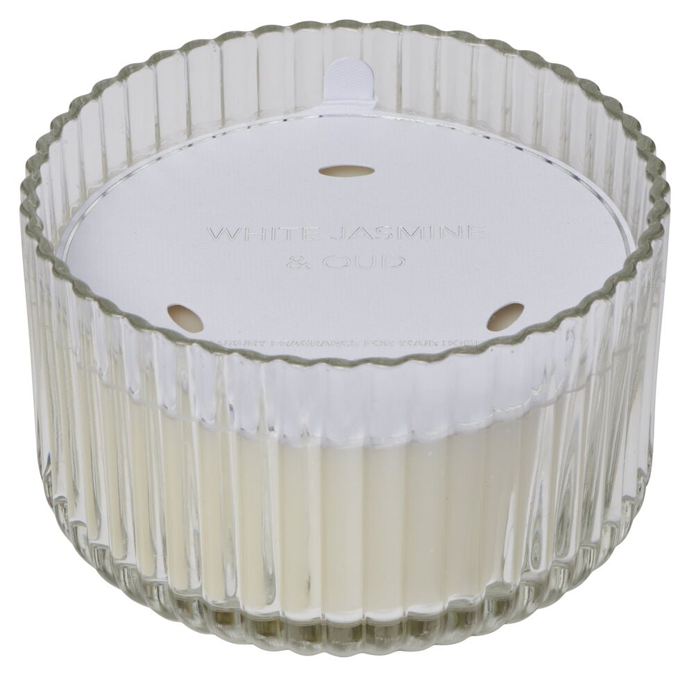 Doftljus i ribbat klart glas med vitt lock.