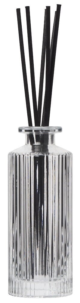 Ribbet glassbeholder med svarte duftpinner.