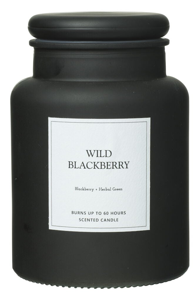 Svart duftlys i glasskrukke med lokk og etikett.