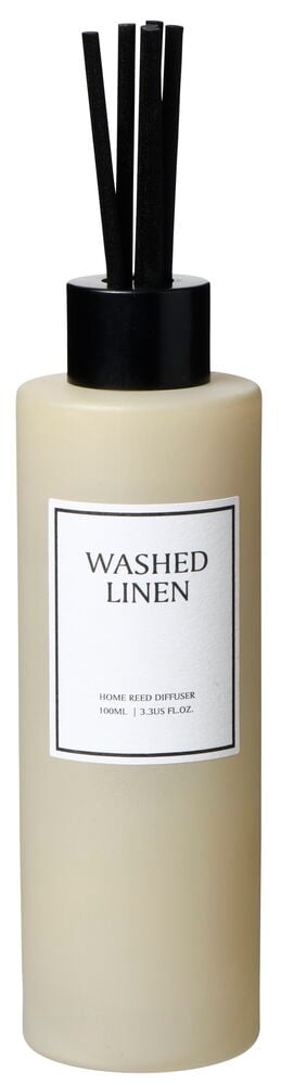 Beige duftpinner i glassflaske med svart dekorativ kork.