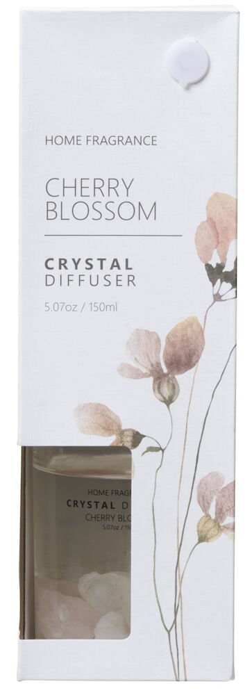 Glasflaska med doftpinnar och vita rosa dekorstenar.