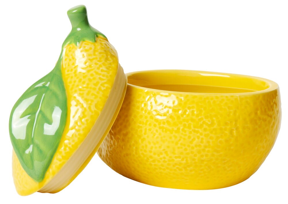 Gelbe Keramikkerze in Zitronenform mit grünem Deckel.