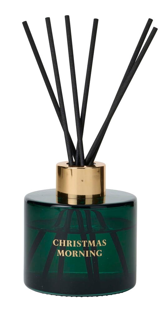 Doftpinnar Merry 100 ml: grön glasflaska, guldtopp, svarta pinnar, samt texten 'Christmas Morning'.