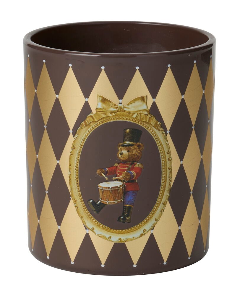 Doftljus Nelly i en brun behållare med ett gulddiamantmönster och en trummande nallebjörnsdesign.