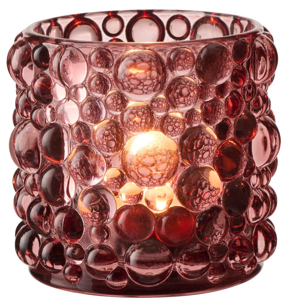 En cylindrisk värmeljushållare i glas med blandade höstfärger och bubbeltextur, upplyst inifrån.
