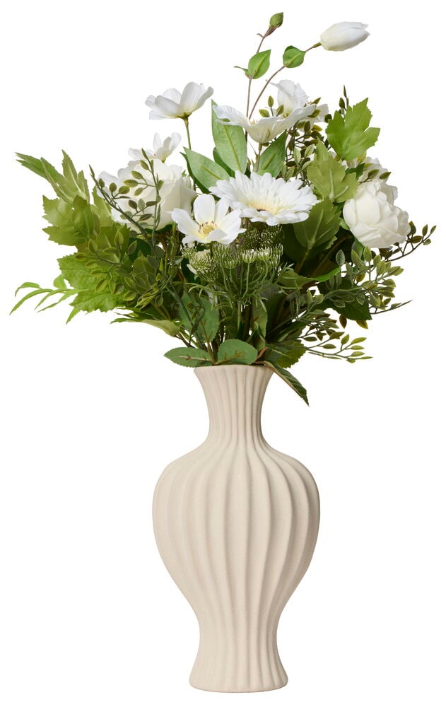 Vit vas med konstgjorda vita blommor och gröna blad.