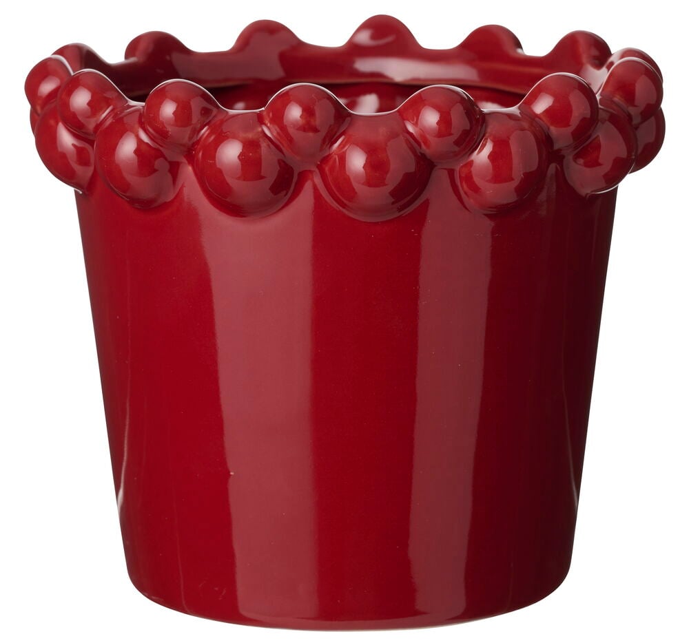 En blank, djupröd keramikkruka Astrid 12 cm med en distinkt vågig, bubbelliknande kant.