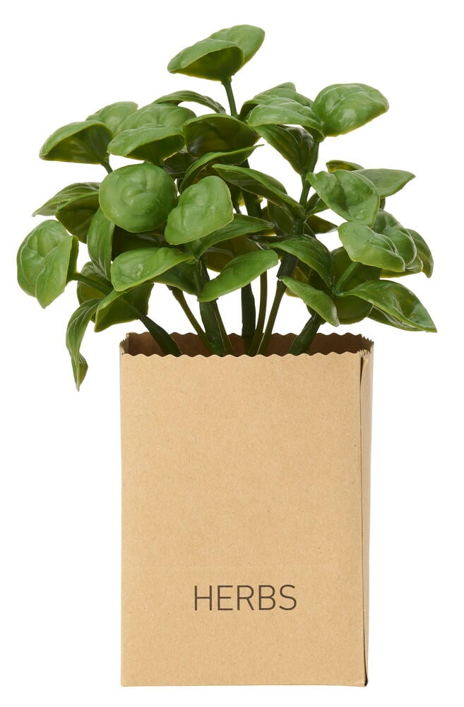Yrtit 3 osaa, vihreä tekokasvi ruskeassa paperiruukussa, jossa on teksti 'HERBS'.