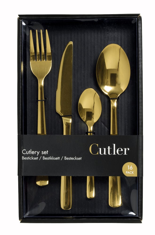 Neljä kultaista ruokailuvälinettä mustassa lahjapakkauksessa.